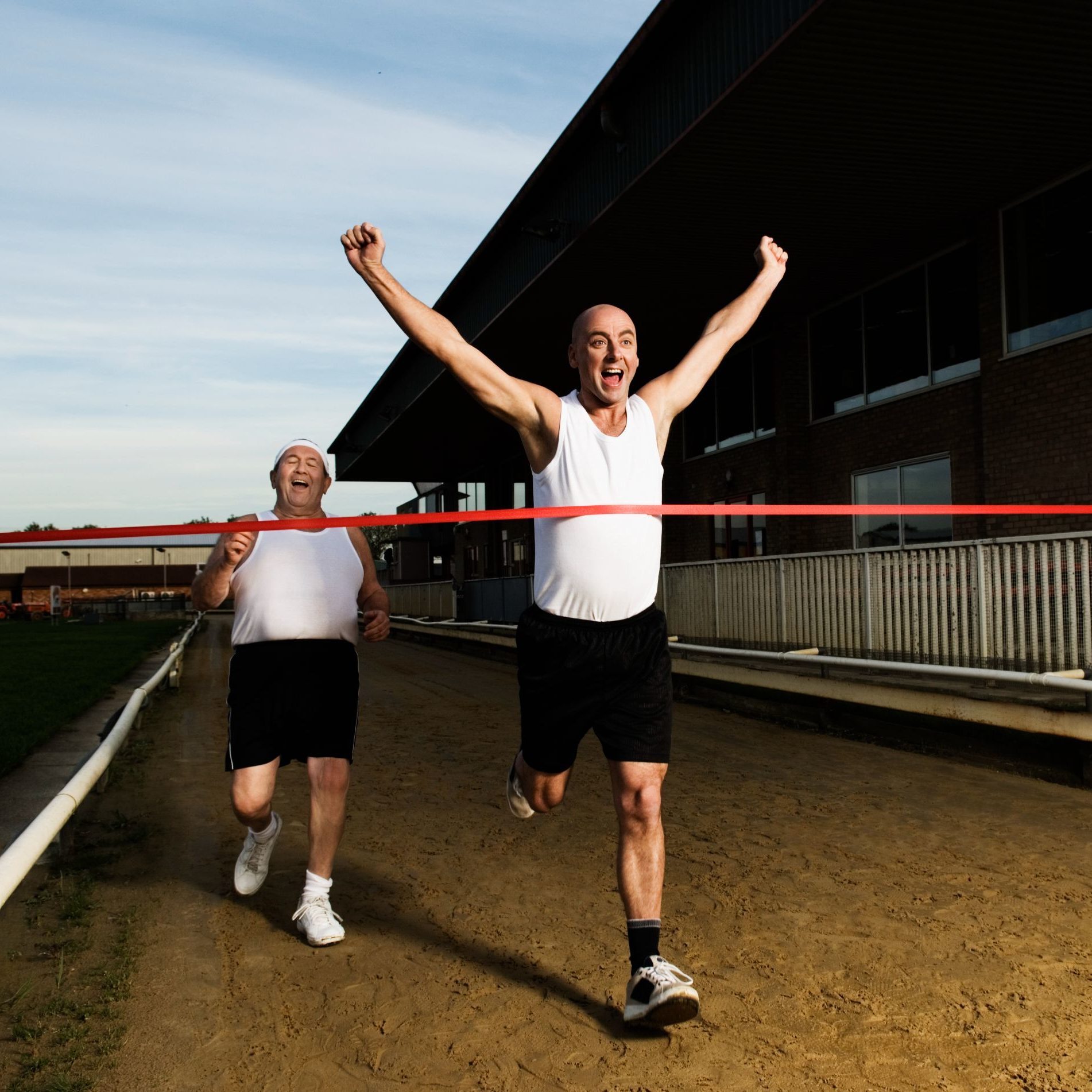 two-men-in-sportswear-running-towards-the-finish